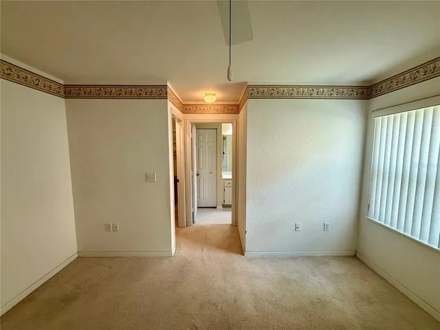 a view of a room with an empty space and a window