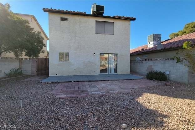 1016 Vantage Point Road Las Vegas, NV 89128 - Photo 17 of 18 Back of property with stucco siding, central air condition unit, a patio, fence, and a tiled roof