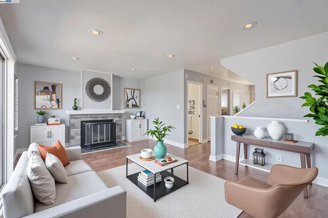 a living room with furniture and a fireplace