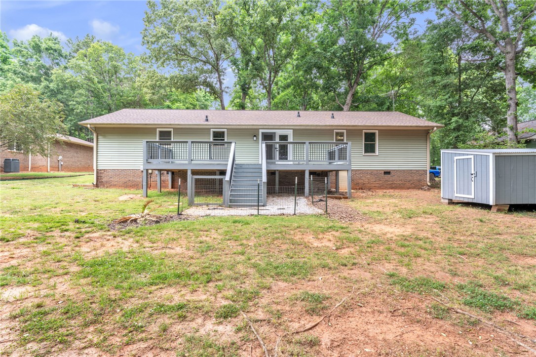 4416 Denver Cove Road Anderson, SC 29625 - Photo 23 of 31 A raised deck and rear entrance offers a pleasant transition to the expansive backyard.