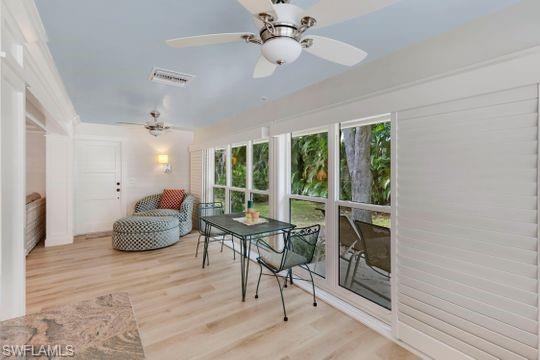 265 Yorkshire Court, Unit 8 Naples, FL 34112 - Photo 16 of 33 Sunroom with plenty of natural light and wood finished floors