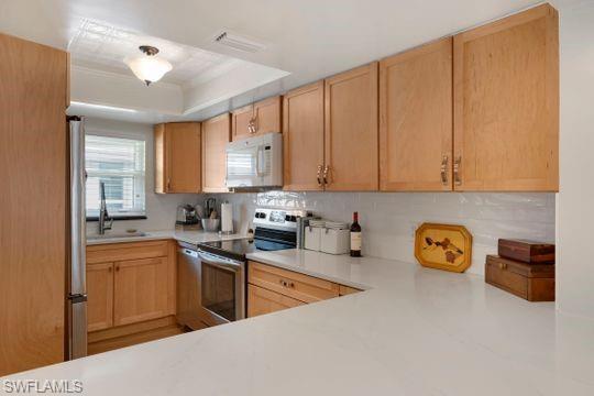 265 Yorkshire Court, Unit 8 Naples, FL 34112 - Photo 25 of 33 Kitchen with light brown cabinets, appliances with stainless steel finishes, and light countertops