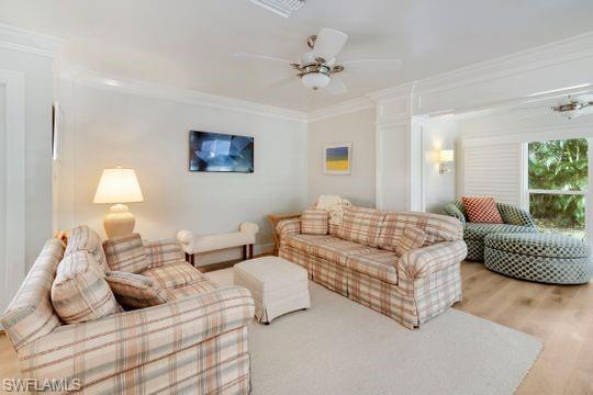 265 Yorkshire Court, Unit 8 Naples, FL 34112 - Photo 28 of 33 Living room with crown molding, ceiling fan, and wood finished floors