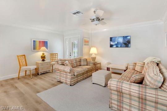 265 Yorkshire Court, Unit 8 Naples, FL 34112 - Photo 29 of 33 Living area with wood finished floors, ceiling fan, and ornamental molding