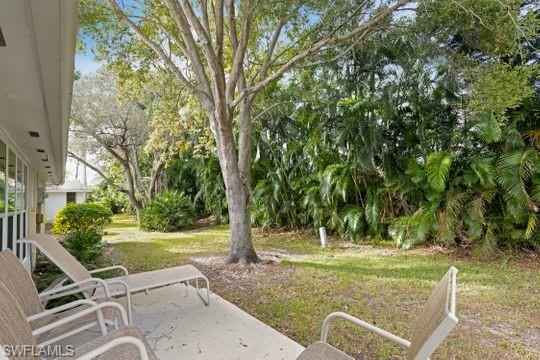 265 Yorkshire Court, Unit 8 Naples, FL 34112 - Photo 5 of 33 View of grassy yard with a patio area