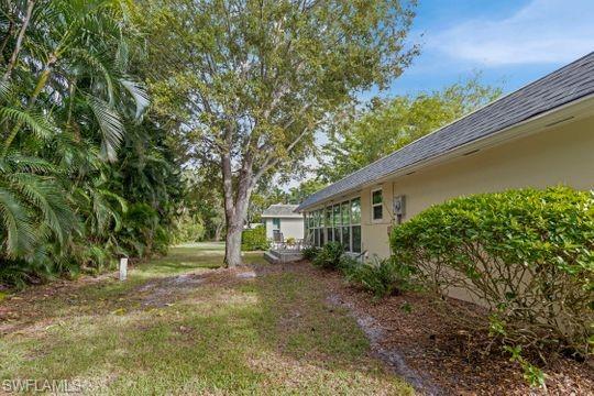 265 Yorkshire Court, Unit 8 Naples, FL 34112 - Photo 6 of 33 View of green lawn with a sunroom