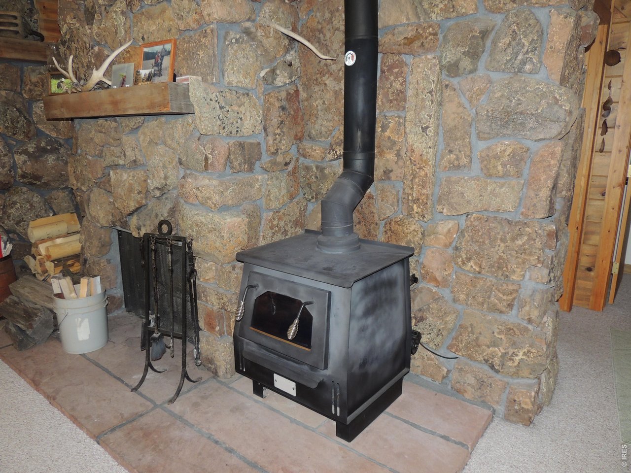 2300 Red Ashby Road Livermore, CO 80536 - Photo 10 of 32 Build in fireplace plus convection wood stove