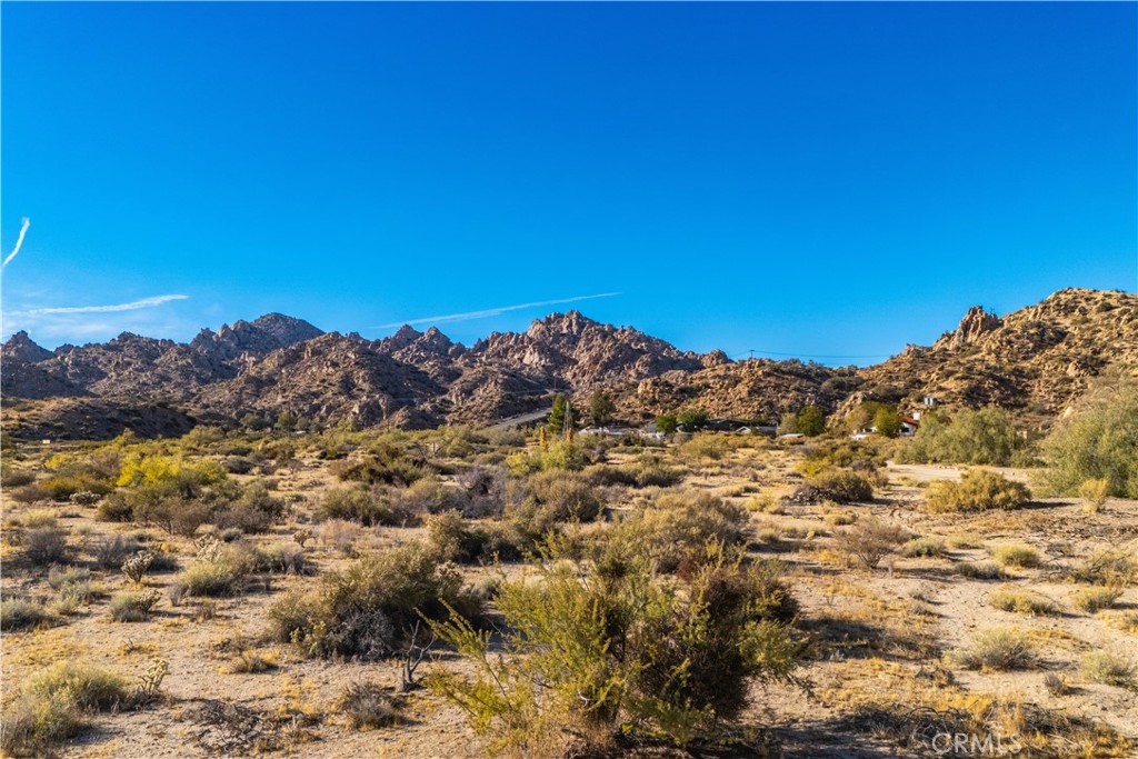 6350 Pioneertown Road Pioneertown, CA 92268 - Photo 14 of 36 a view of a large building with mountains in the background