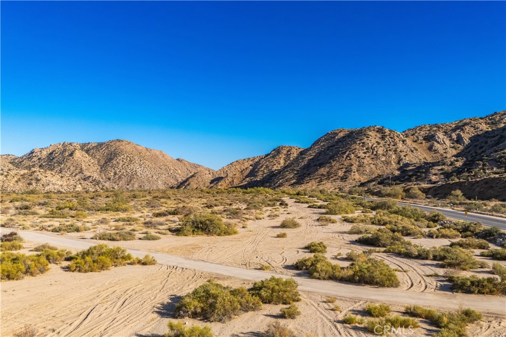 6350 Pioneertown Road Pioneertown, CA 92268 - Photo 23 of 36 a view of a large mountain with wooden fence