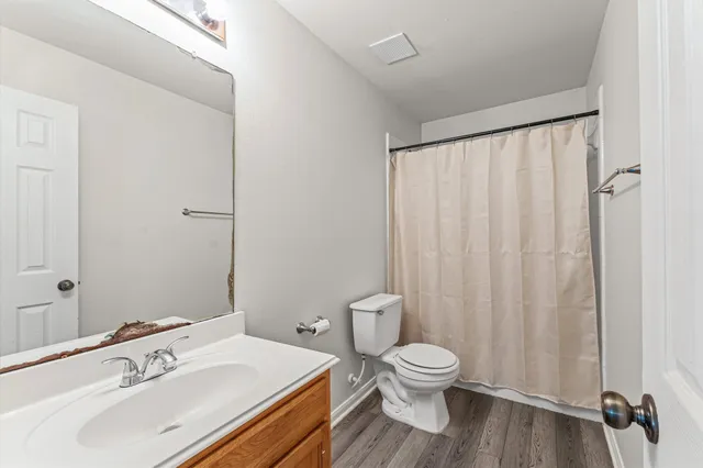 a bathroom with a toilet a sink and a mirror