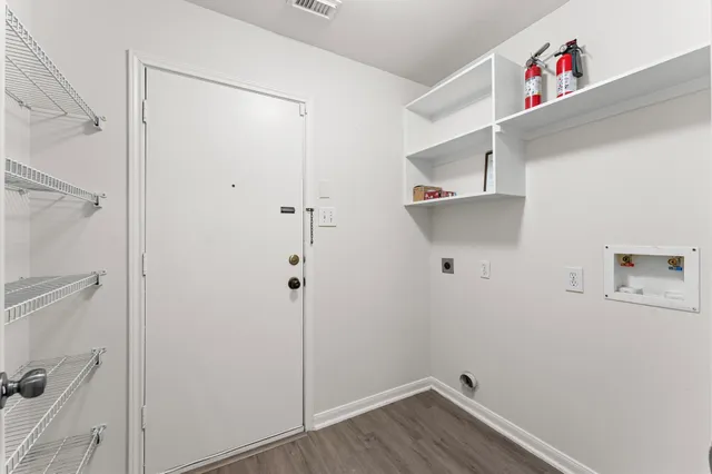 a room with a walk in closet and wooden floor