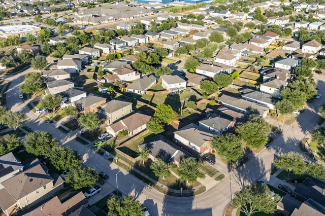 an aerial view of residential houses with outdoor space
