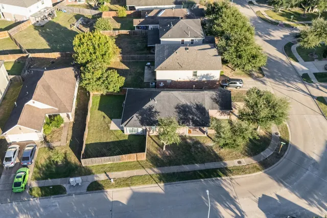an aerial view of a house with a yard basket ball court