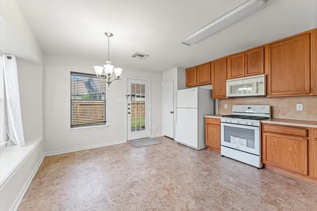 a kitchen with stainless steel appliances granite countertop a stove cabinets and a refrigerator