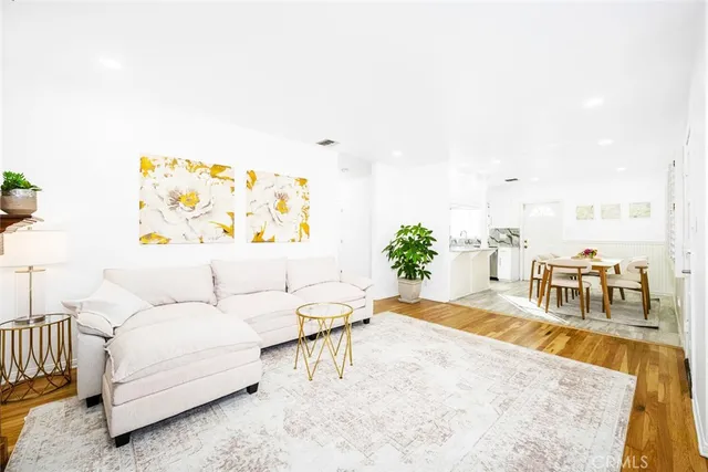 a living room with furniture and a painting on the wall
