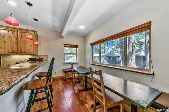 a view of a dining room with furniture window and wooden floor