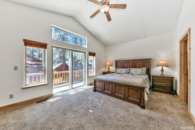 a spacious bedroom with a bed and a large window
