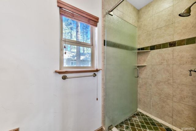 a bathroom with a window and shower