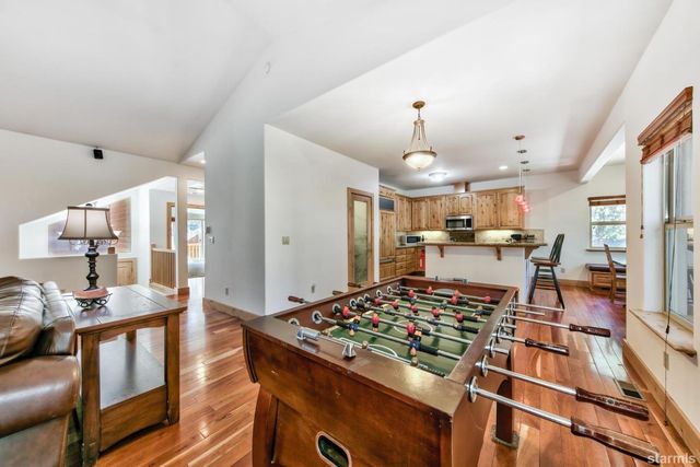 a large kitchen with a table and chairs
