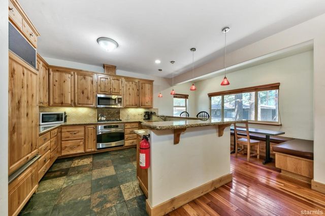 a kitchen with a sink stove and refrigerator