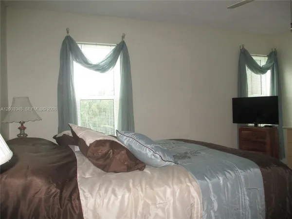 a bed sitting in a bedroom next to a window