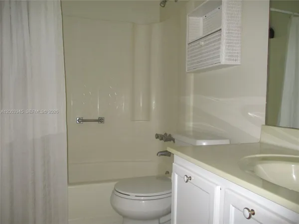 a bathroom with a granite countertop sink
