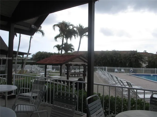 a view of a chairs and table in patio with a lake view
