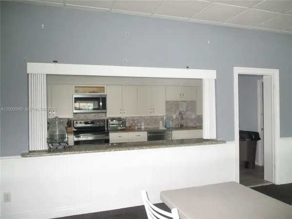a view of a dining room with furniture and a window