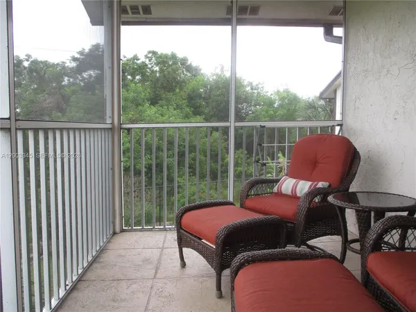 a view of a livingroom with furniture and a potted plant