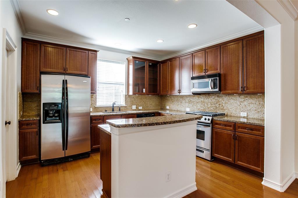1600 Abrams Road, Unit 8 Dallas, TX 75214 - Photo 14 of 26 a kitchen with stainless steel appliances granite countertop wooden cabinets a refrigerator a stove a sink and a microwave