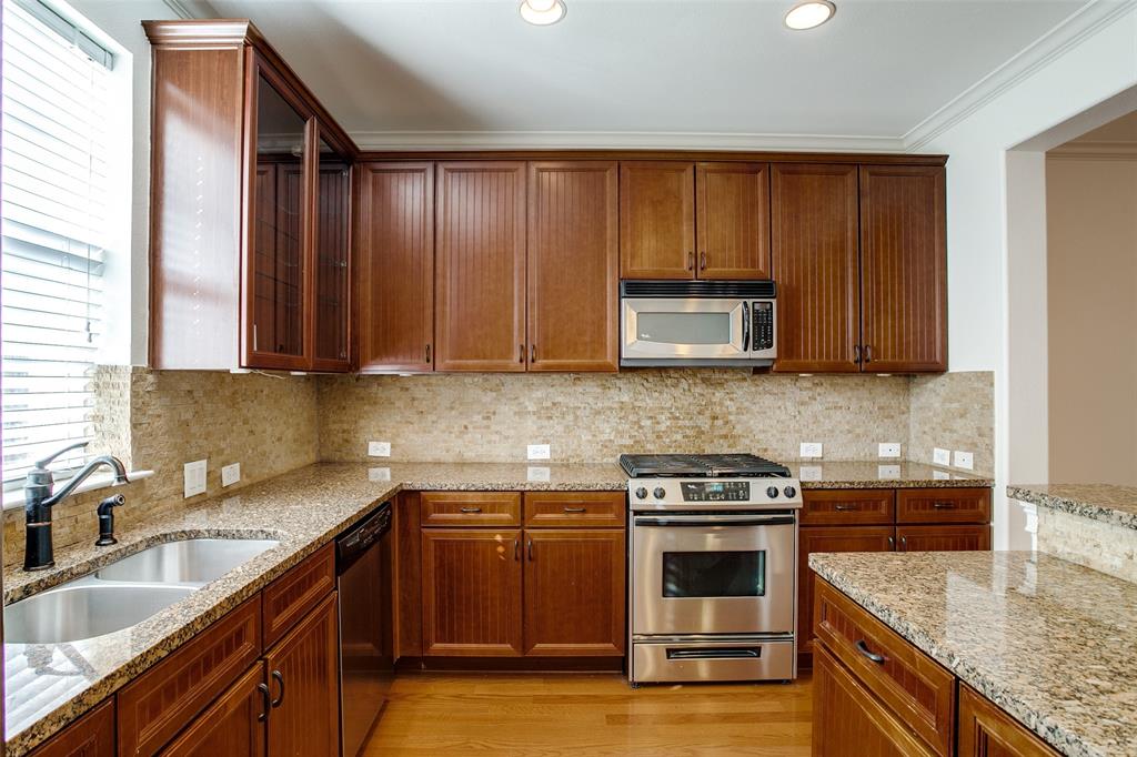 1600 Abrams Road, Unit 8 Dallas, TX 75214 - Photo 15 of 26 a kitchen with granite countertop stainless steel appliances a stove a sink and a microwave