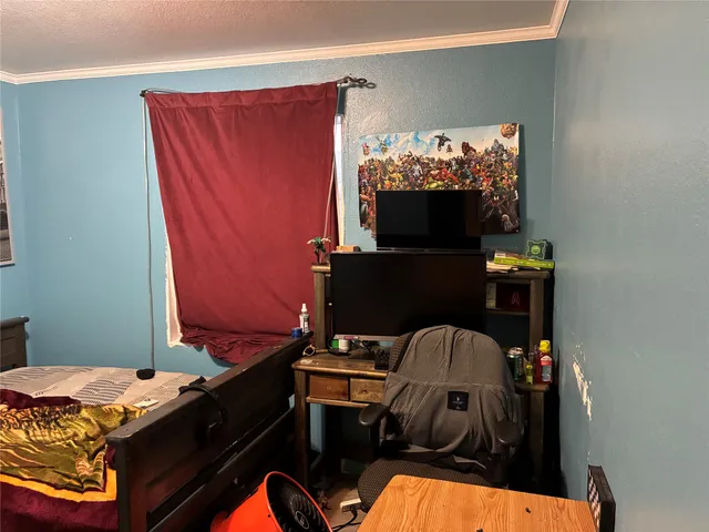 a bedroom with a bed and dresser