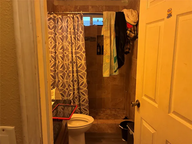 a bathroom with a toilet and shower
