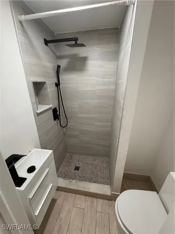 a bathroom with a sink toilet and shower