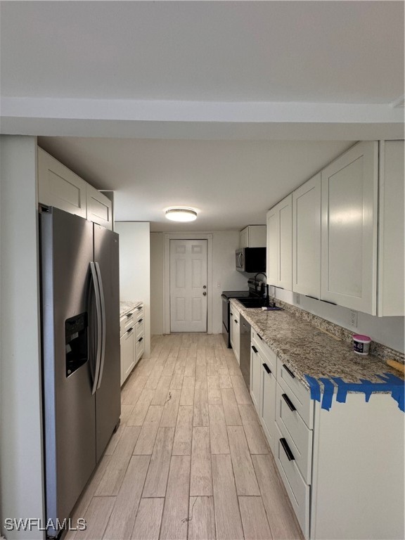 15344 Wall Drive Fort Myers, FL 33908 - Photo 18 of 21 a large kitchen with a center island wooden floor stainless steel appliances and cabinets
