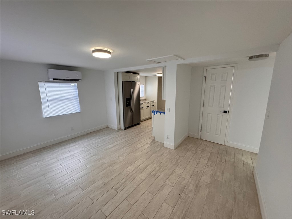 15344 Wall Drive Fort Myers, FL 33908 - Photo 19 of 21 a view of an empty room with wooden floor and a window