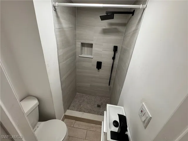 a bathroom with a toilet and a shower