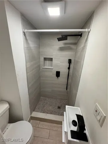a bathroom with a toilet and shower