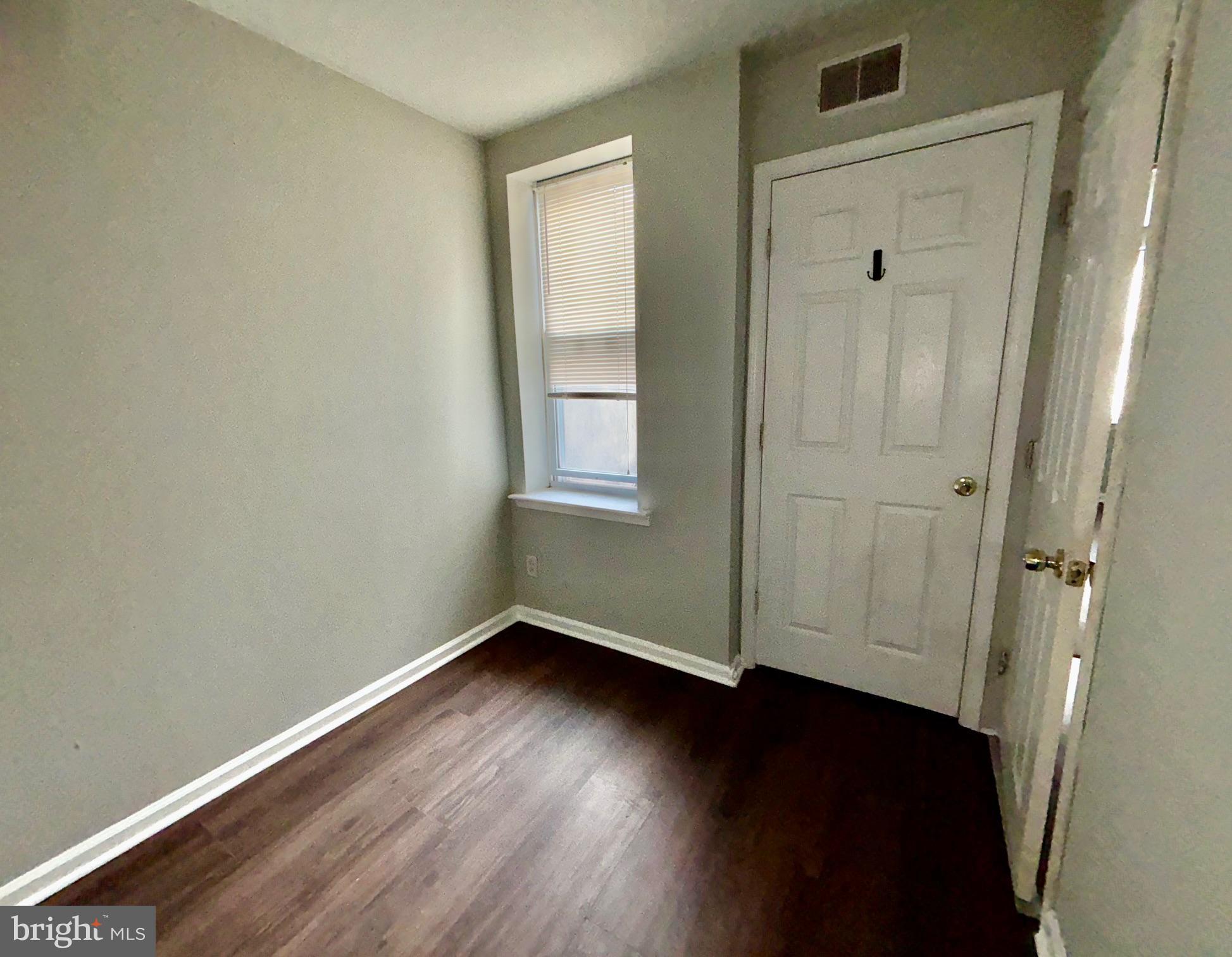 5258 Hazel Avenue Philadelphia, PA 19143 - Photo 12 of 22 an empty room with wooden floor and windows