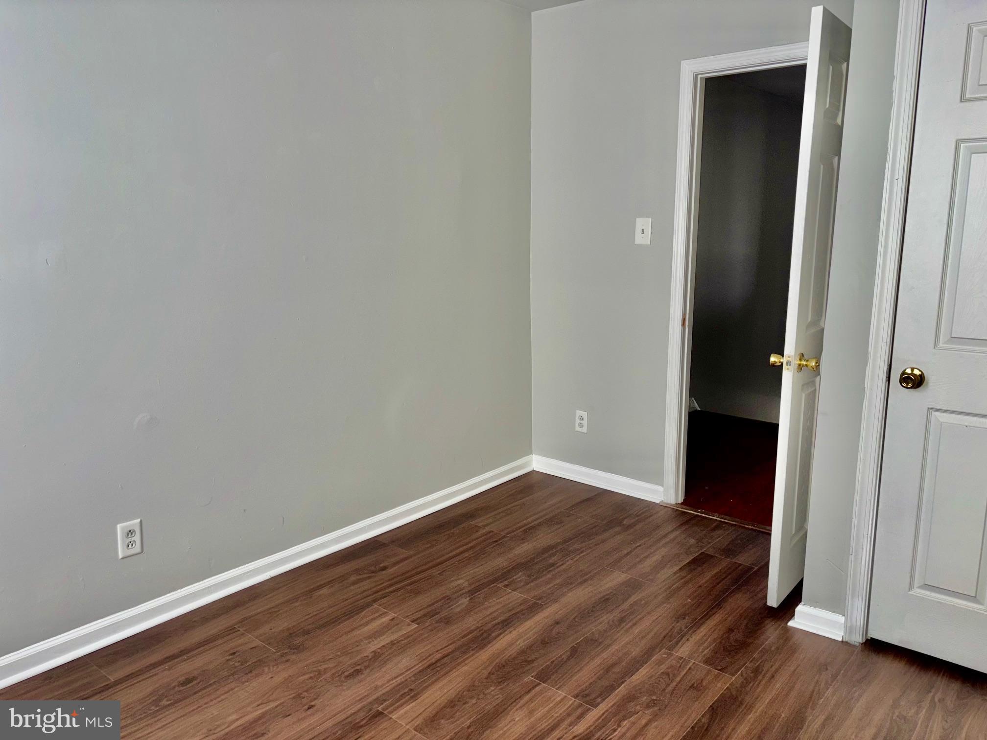 5258 Hazel Avenue Philadelphia, PA 19143 - Photo 14 of 22 an empty room with wooden floor and closet