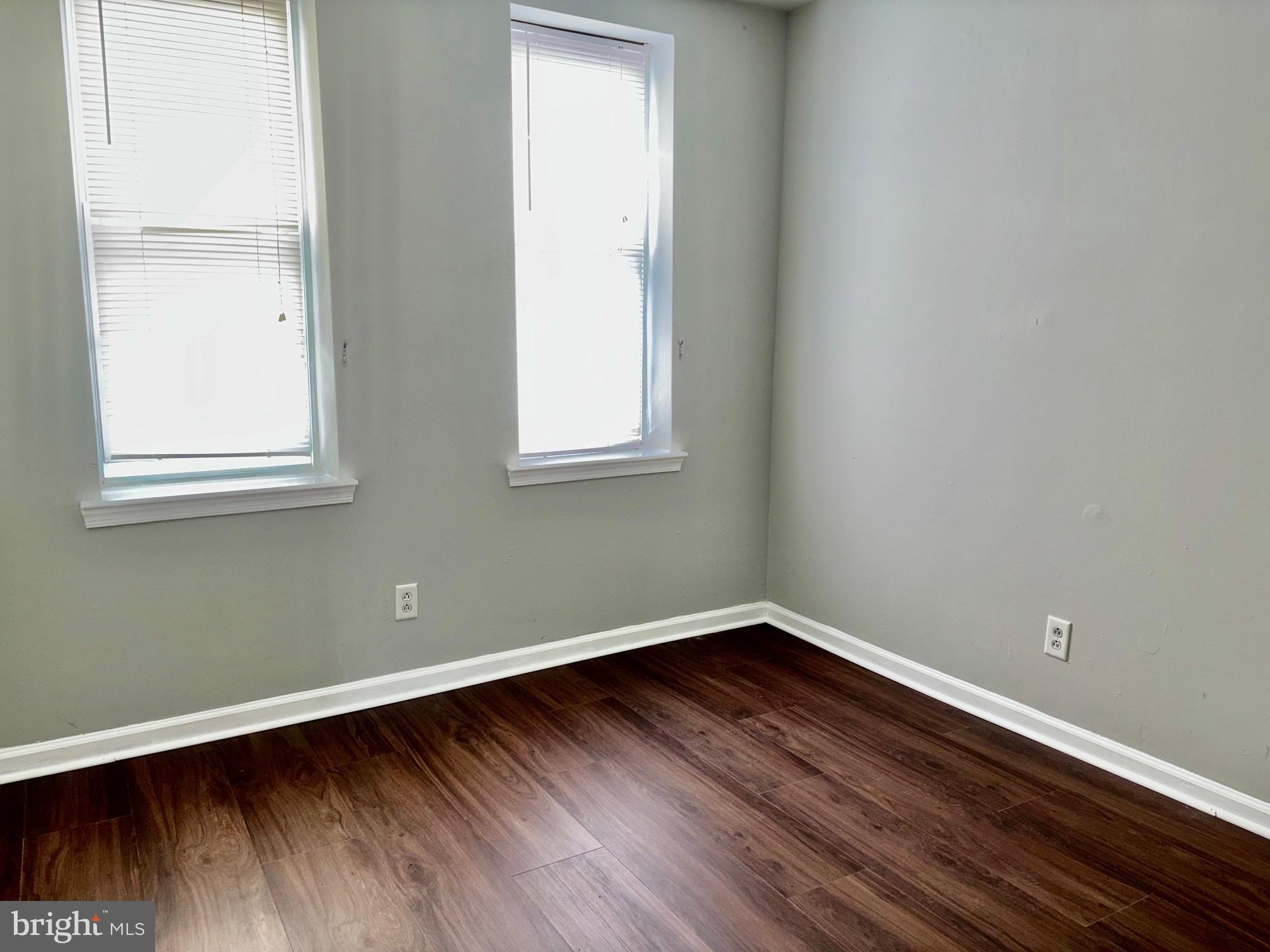 5258 Hazel Avenue Philadelphia, PA 19143 - Photo 15 of 22 an empty room with wooden floor and windows