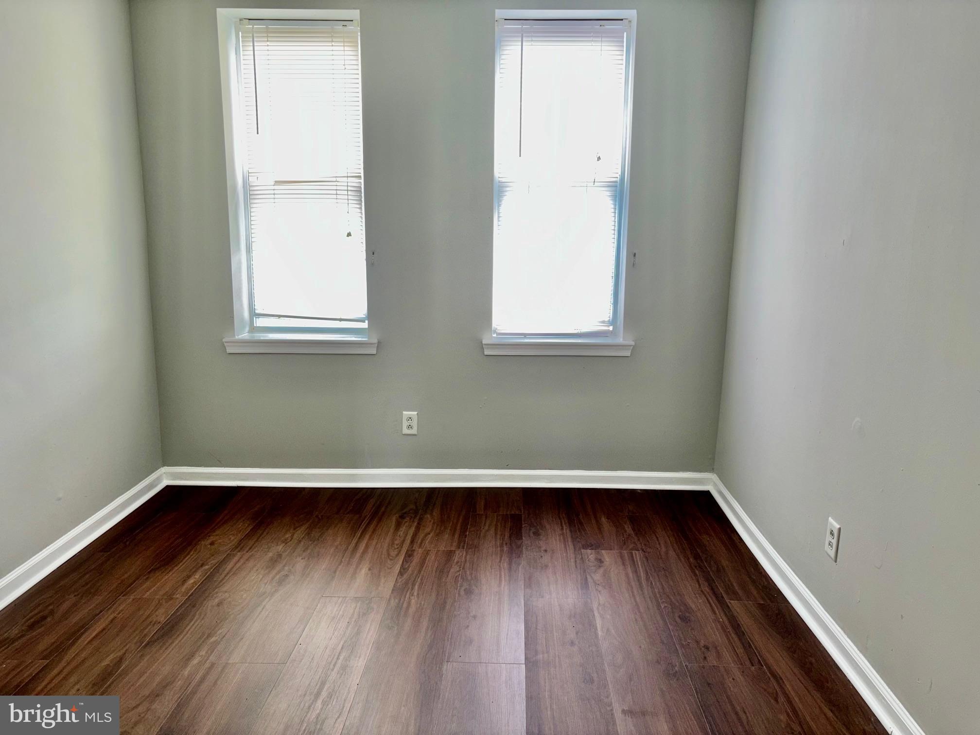 5258 Hazel Avenue Philadelphia, PA 19143 - Photo 16 of 22 an empty room with wooden floor and windows