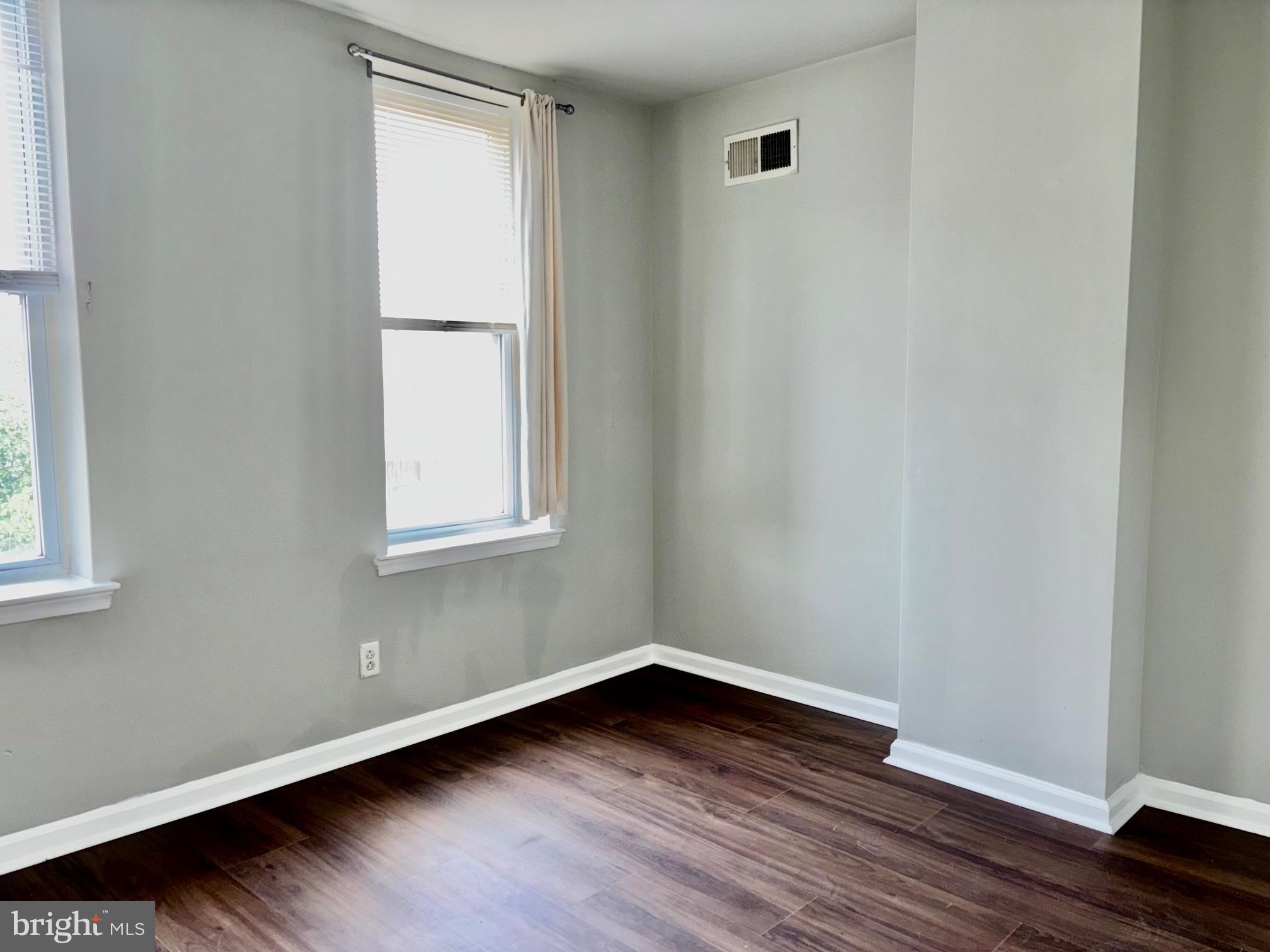 5258 Hazel Avenue Philadelphia, PA 19143 - Photo 18 of 22 a view of an empty room with wooden floor and a window