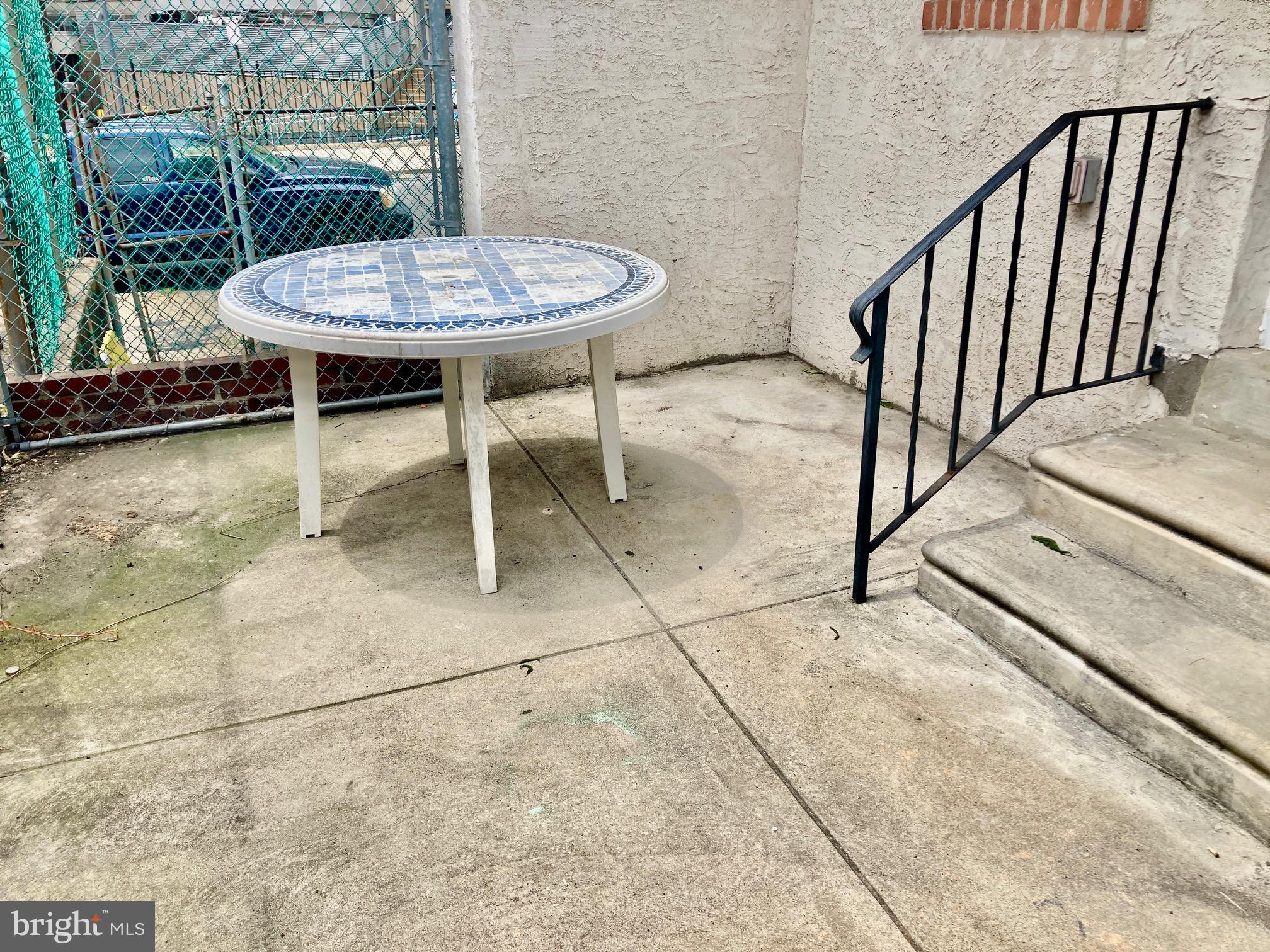 5258 Hazel Avenue Philadelphia, PA 19143 - Photo 6 of 22 a view of a patio with a table and chairs