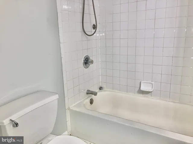 a bathroom with a bathtub a toilet and a shower