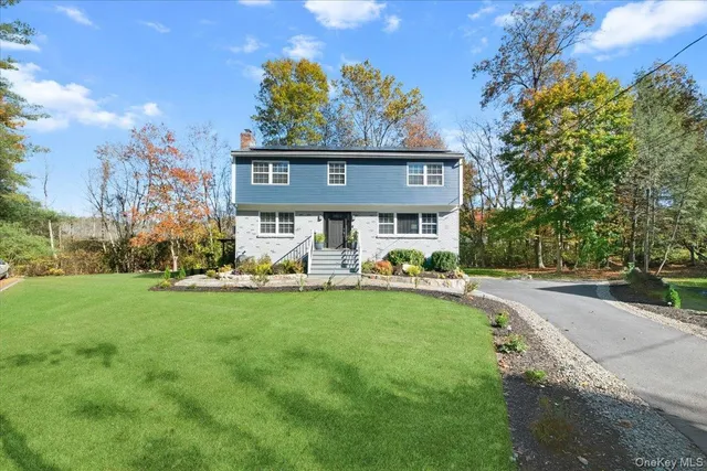 a view of a house with swimming pool and sitting area