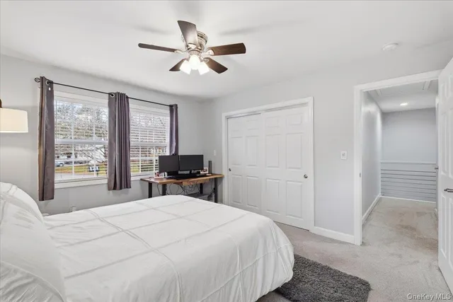 a spacious bedroom with a bed a couch and a window