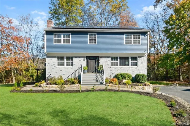 a front view of house with yard and green space