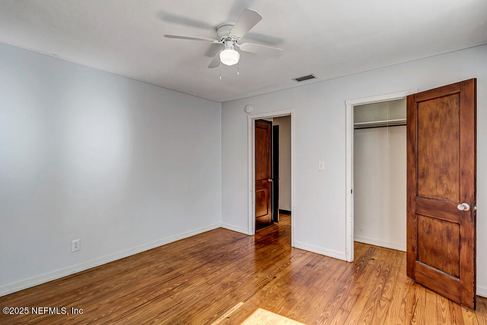 60 Weeden Street St. Augustine, FL 32084 - Photo 16 of 46 an empty room with wooden floor and a ceiling fan