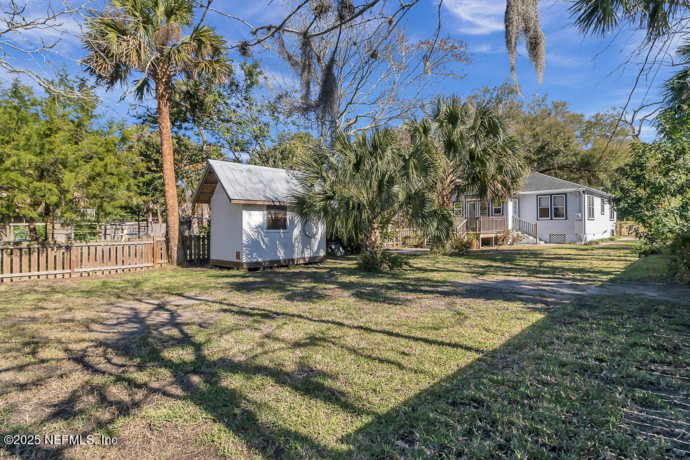60 Weeden Street St. Augustine, FL 32084 - Photo 28 of 46 a backyard of a house with table and chairs